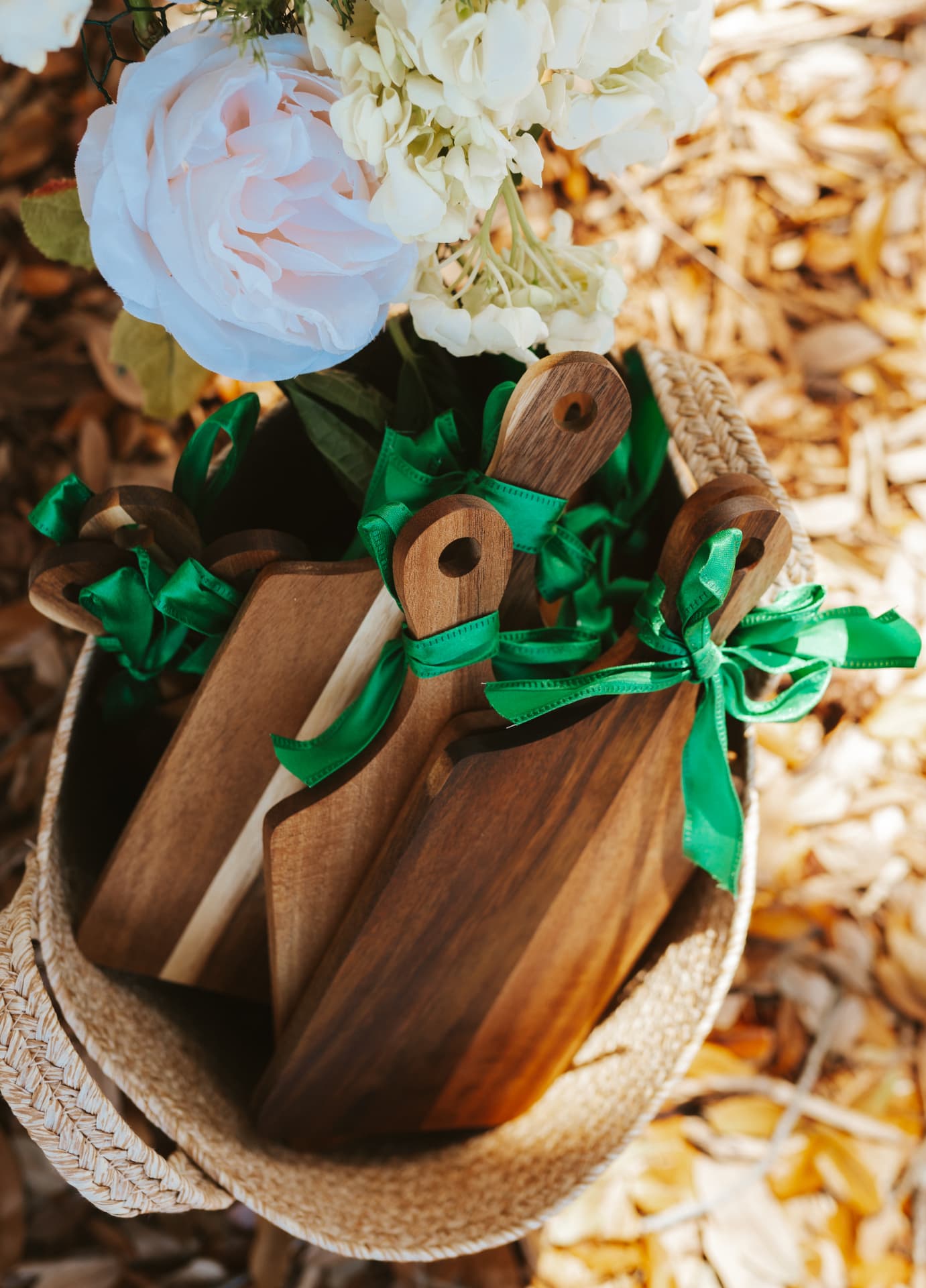 A basket of wooden serving boards styled with florals