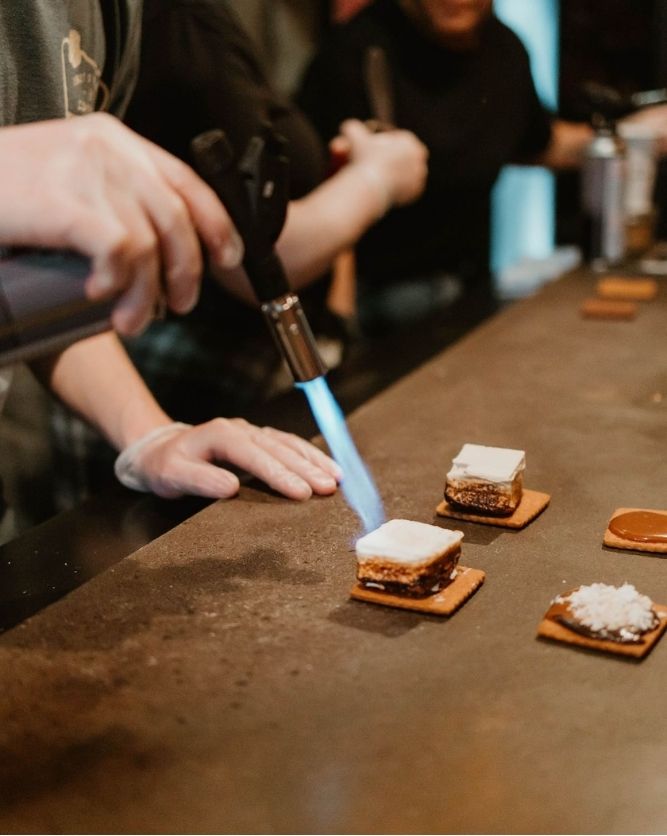 A s'more being torched to order at the s'mores bar
